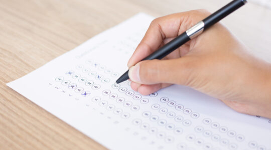 Closeup of Person Filling out Questionary Form