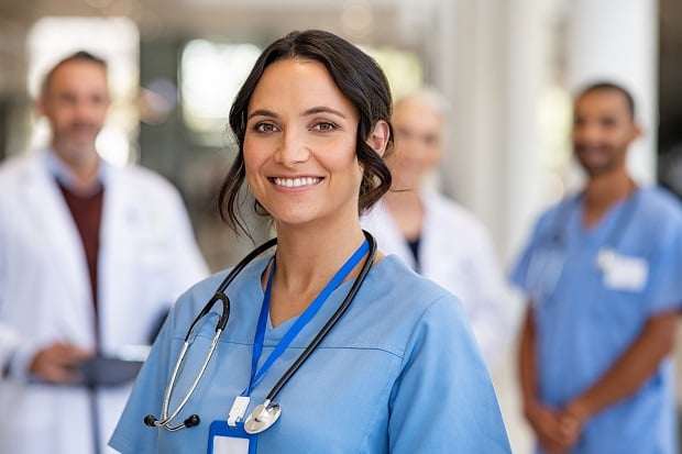 Portrait,Of,Happy,Young,Nurse,In,Uniform,With,Healthcare,Team