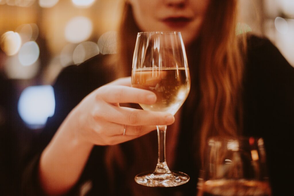 holding-a-glass-of-wine-2023-11-27-05-29-39-utc