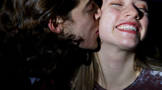 man-kissing-woman-with-spangles-face