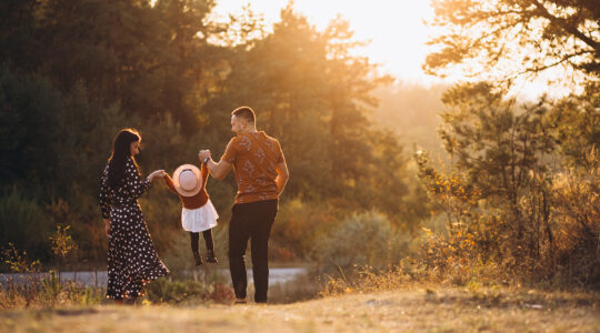 Family with their little daughter in an autumn field