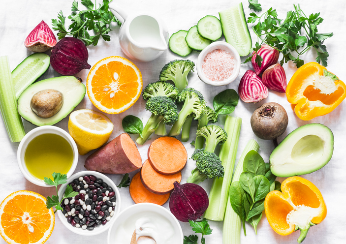 Five best vitamins for beautiful skin. Products with vitamins A, B, C, E, K – broccoli, sweet potatoes, orange, avocado, spinach, peppers, olive oil, dairy, beets, cucumber, beens. Flat lay, top view