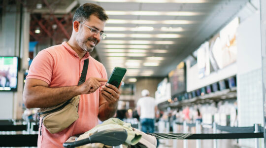 Mature man at airport waiting for check in