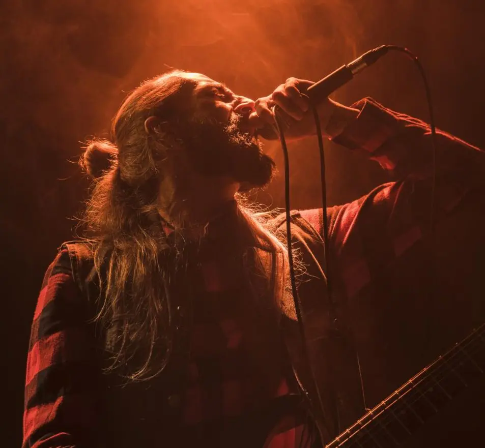 long-hair-guitar-guy-singing-low-view (1)
