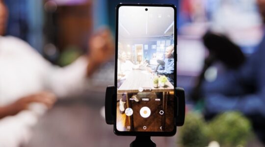 Smartphone on tripod records influencers