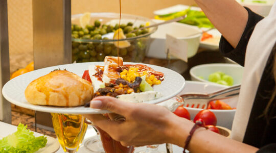 Woman preparing delicious meal in a kitchen . side view.