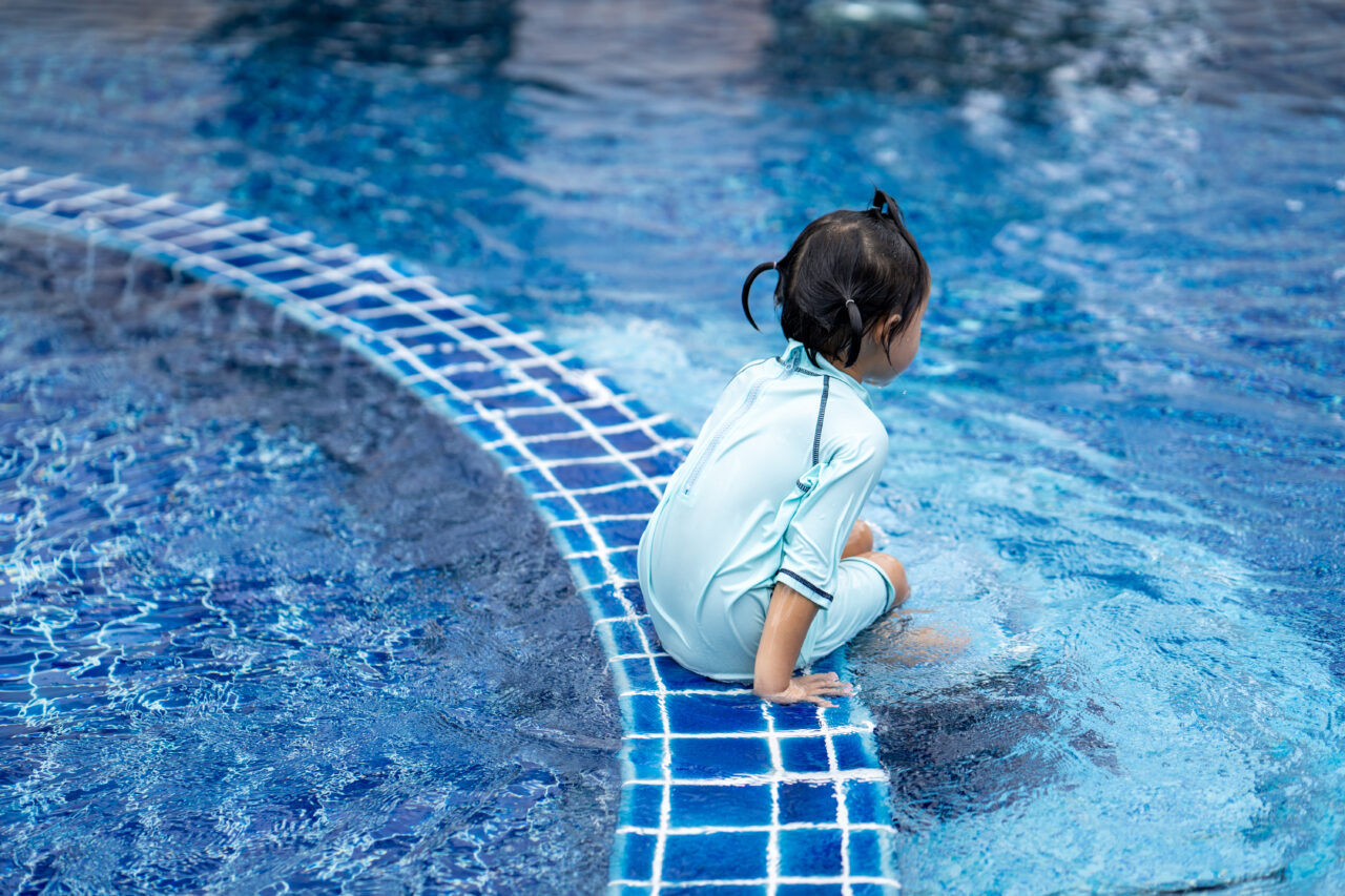 Cute Asian small girl in a pool