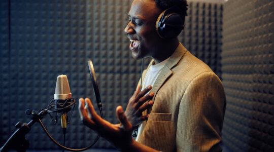 Male singer sings a song, recording studio