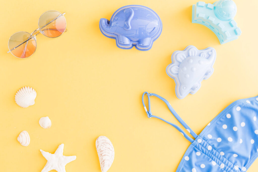 composition-with-holiday-summer-beach-accessories-yellow-background