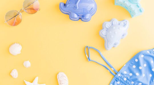 composition-with-holiday-summer-beach-accessories-yellow-background