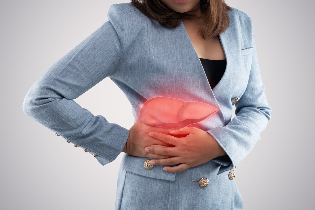 The photo of liver on woman’s body against gray background, Hepa