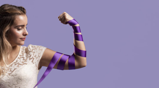 woman-flexing-her-arm-with-ribbon-copy-space