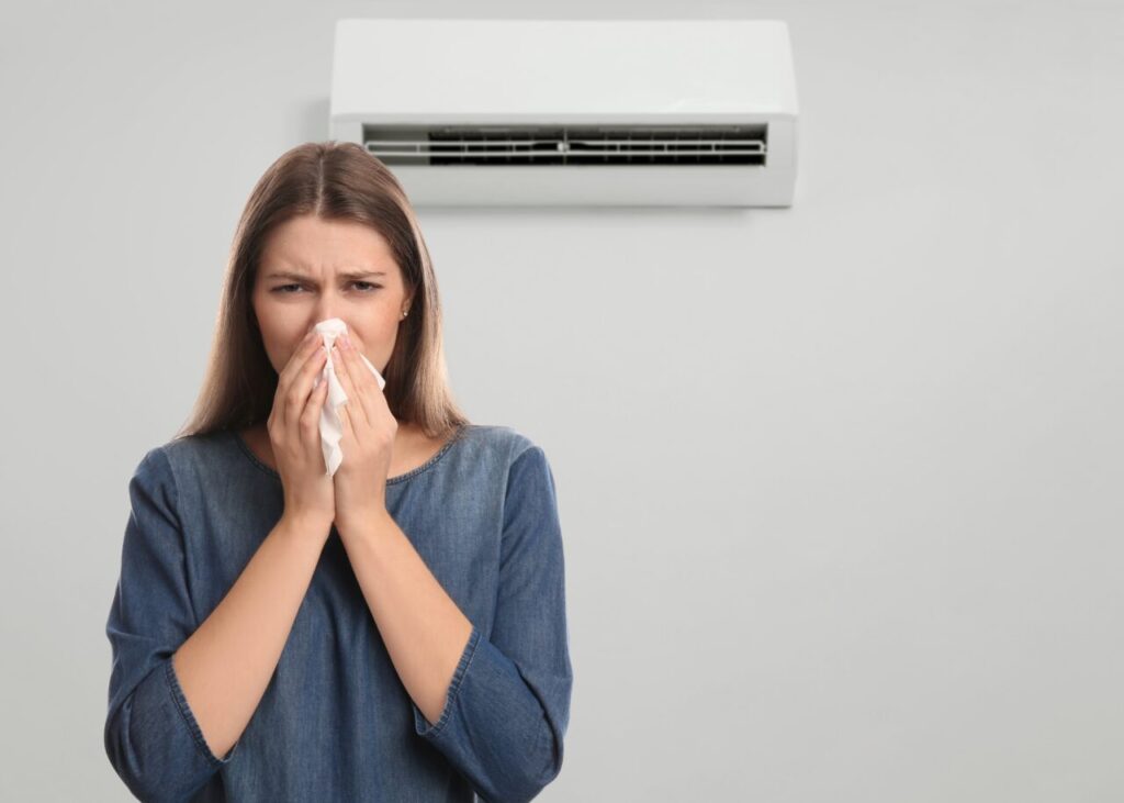 Woman,Suffering,From,Cold,In,Room,With,Air,Conditioner,On