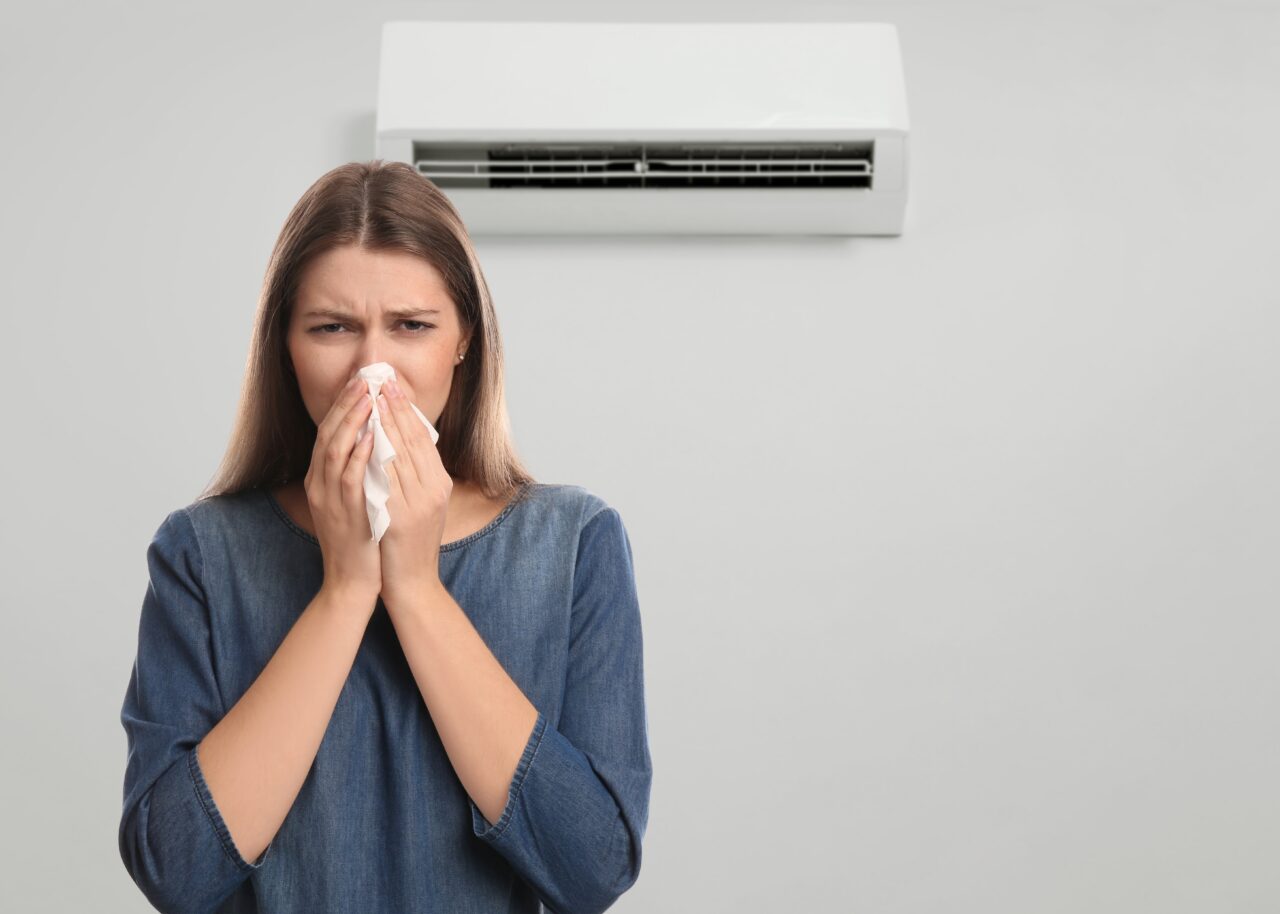Woman,Suffering,From,Cold,In,Room,With,Air,Conditioner,On