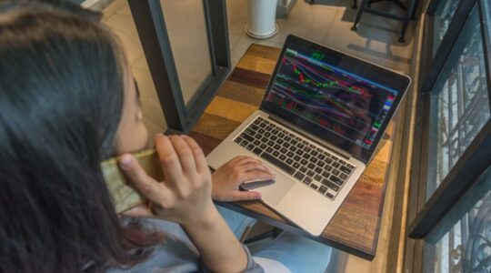Stock Trader analyzing stock market and make a phone call
