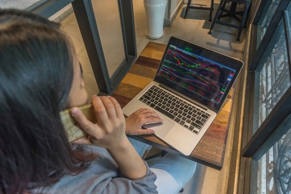 Stock Trader analyzing stock market and make a phone call