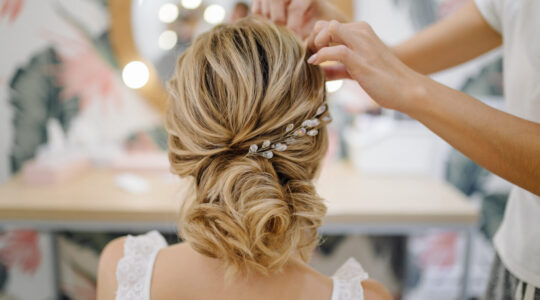 Hairdresser woman weaving braid hair, wedding styling.