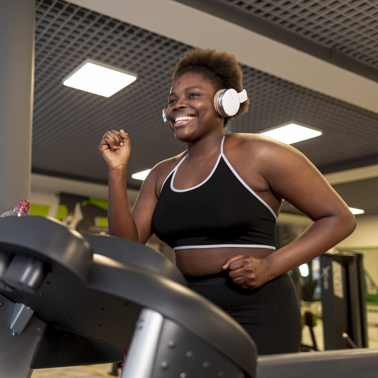 low-angle-smiley-female-running-treadmill