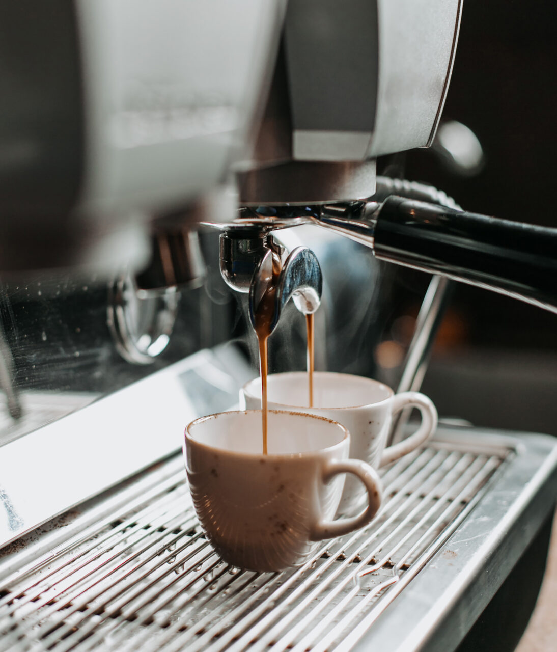 two espresso cups under coffee engine