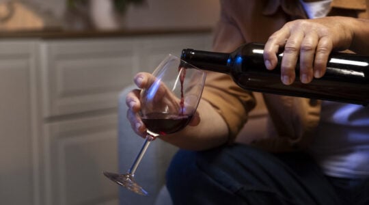 man-enjoying-wine-while-being-home-alone
