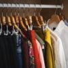 Lot of different clothes hanging in a wardrobe