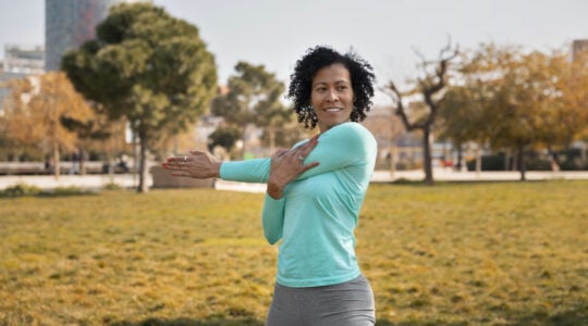 senior-woman-doing-yoga-outdoors-park