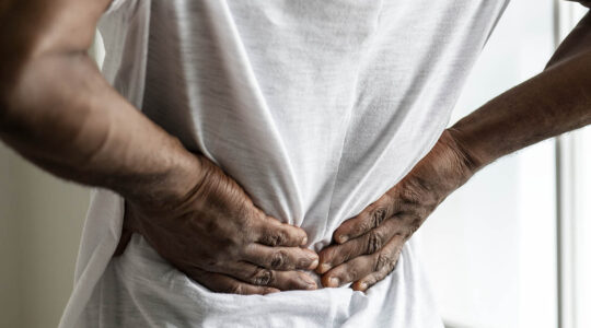 Black man suffering back pain