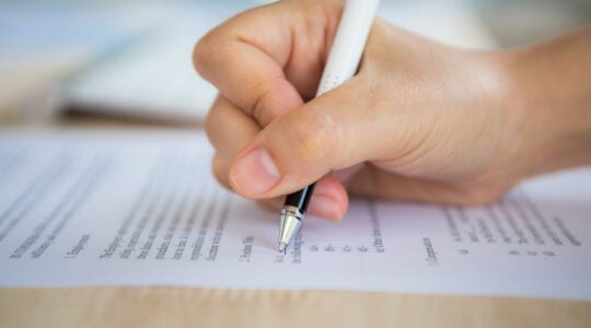 Close up of hand completing an employment application form