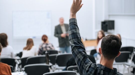 A famous professor has arrived at the university to conduct a special lesson, the student pulls his hand up to ask him a question