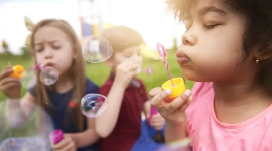 close-up-happy-kids-playing-with-soap-bubbles.jpg
