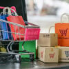 Boxes, bags, shopping cart on a laptop computer keyboard