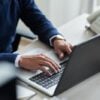 high-angle-view-cropped-employee-work-with-laptop–1-_700