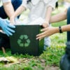 Woman’s hand picks up plastic waste for cleaning into recycle bag for cleaningat the park. Clearing, pollution, ecology