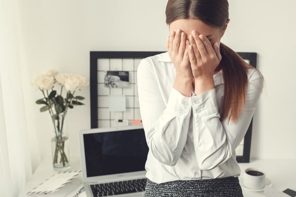 Young woman freelancer indoors home office concept formal style sad