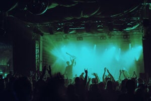 Cheering crowd having fun at music festival in a nightclub