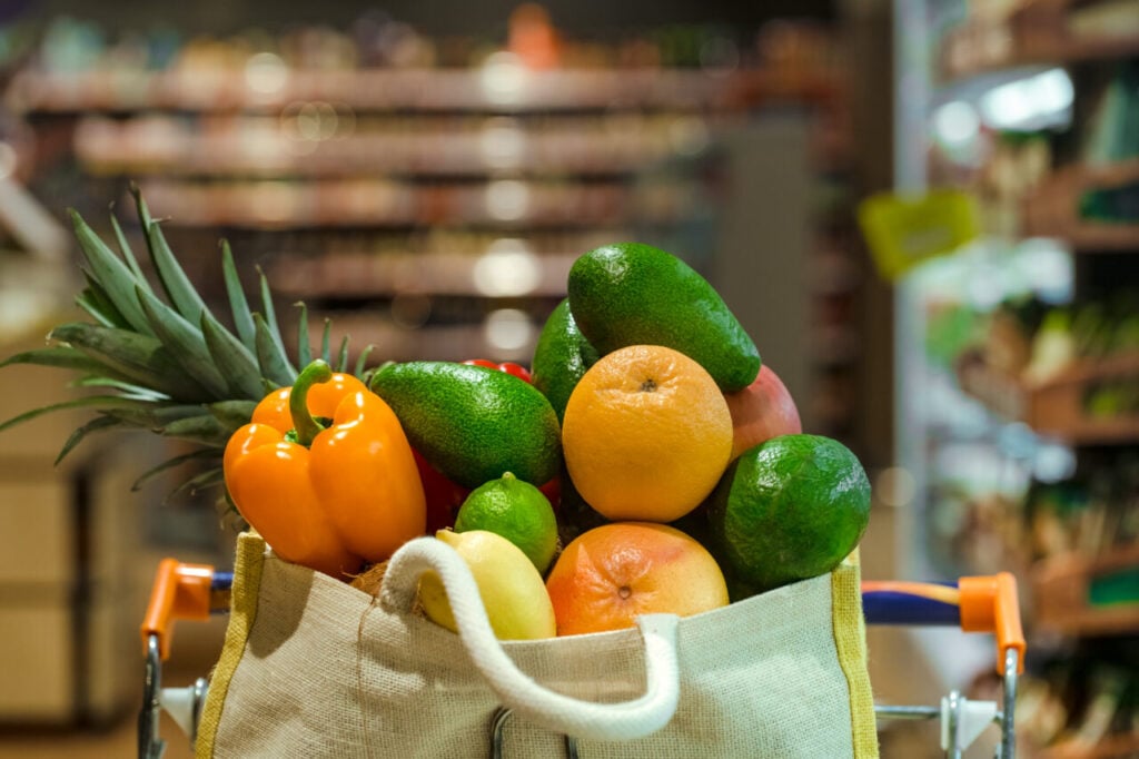 Eco bag with different fruits and vegetables. Shopping in the supermarket.