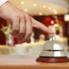 Hand of a man using a hotel bell